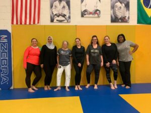 Students celebrating after completing the Women's Self-Defense class at One Spirit Martial Arts in Northern Virginia.