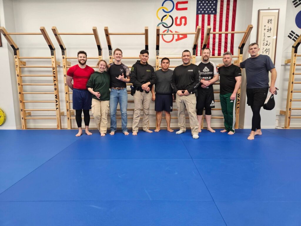Nine participants, including the instructor, posing for a group photo after a Brazilian Jiu-Jitsu seminar at Bethesda Martial Arts in Bethesda, MD.