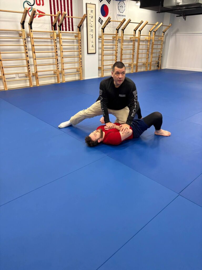 Instructor Ortiz applying knee-on-belly control to a training partner during a Brazilian Jiu-Jitsu For Police Officers seminar at Bethesda Martial Arts in Bethesda, MD.